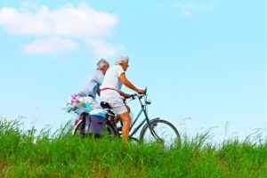 The picture of two senior citizen enjoying their bike ride in the country side.