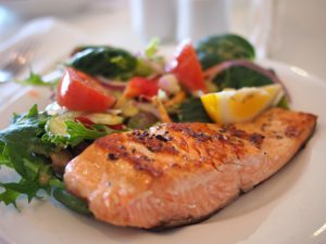 Picture of a well balanced meal, illustrating salmon, and healthy sides.