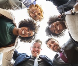 The picture of a group of friends that encircled each other, that seem to be very happy.