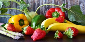 The picture of delicous looking fruits and vegetables, arranged on a table.