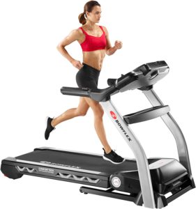 The picture of a woman during her exercise routine on a bowflex treadmill.