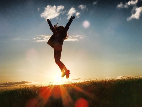 Myohealth reviews. The colorful illustration of a woman elevating her arms into the sky on the hillside during sunset. The staement of second chance.